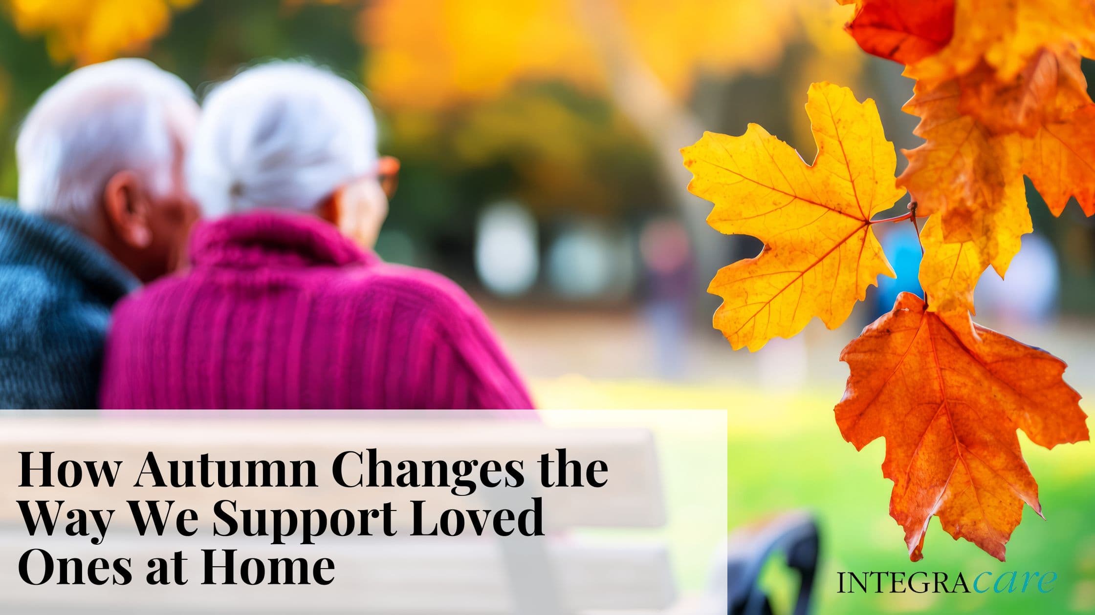 Elderly couple in warm sweaters sitting on a park bench with vibrant fall leaves, illustrating seasonal changes in at-home support – Integracare.