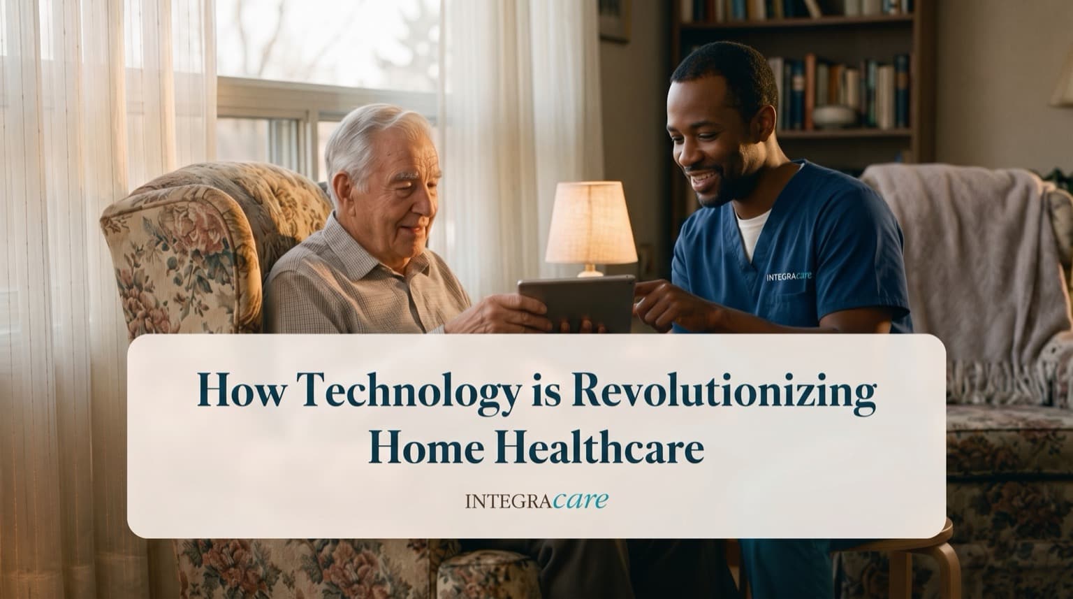 Caregiver in scrubs showing a senior man something on a tablet as they sit together in his living room
