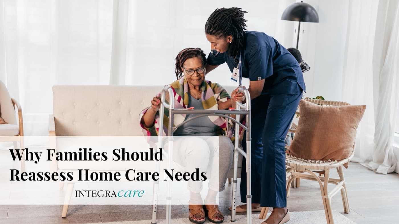 Home care nurse assisting elderly woman with a walker as family reassesses care needs, representing Integracare’s compassionate in-home support services.