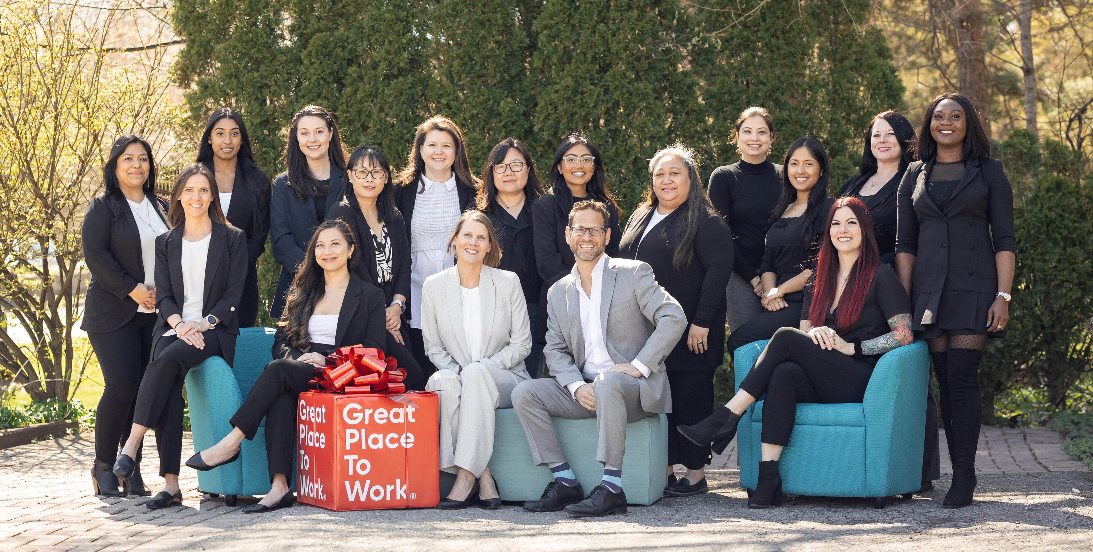 The Integracare team together outdoors with their Great Place to Work award