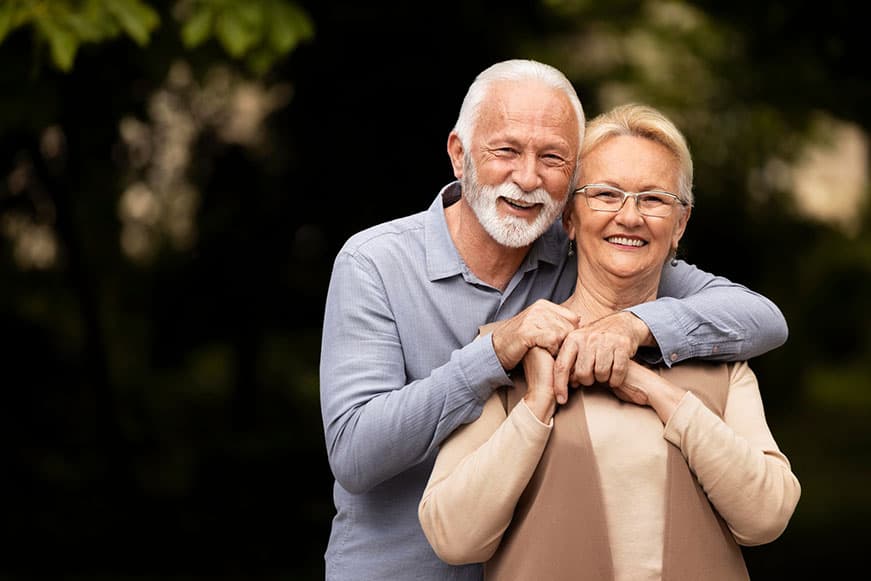 Picture of seniors outside with arms around one another