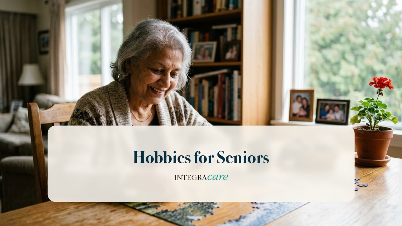 Smiling senior woman assembling a jigsaw puzzle at her dining table at home, with bookshelves and family photos behind her