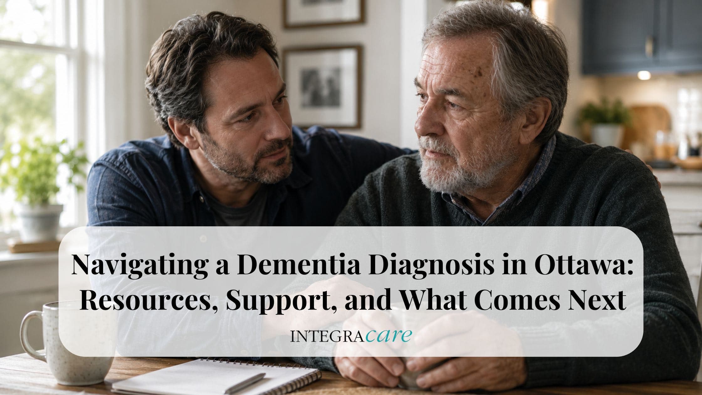 Adult son sitting beside his elderly father at home after a dementia diagnosis, representing family support, guidance, and home care resources available in Ottawa