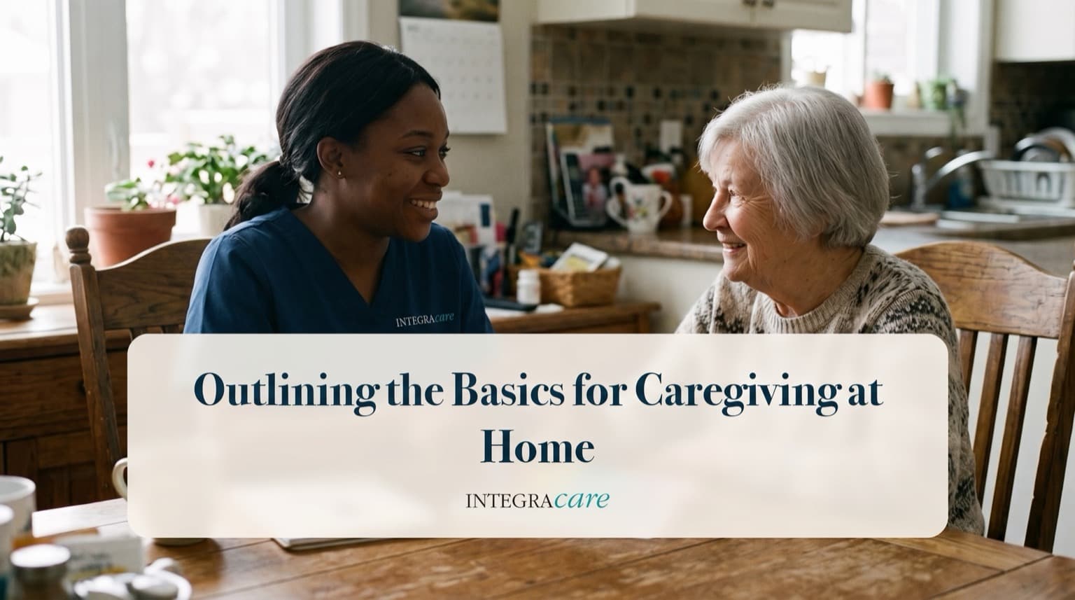 Caregiver in scrubs and a senior woman smiling at each other across a kitchen table during a friendly visit at home