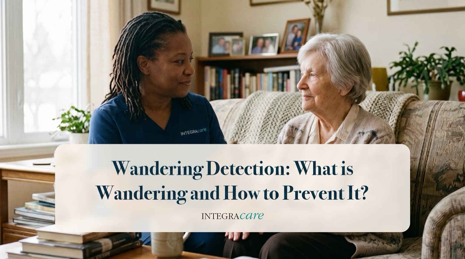A caregiver sits with an older woman on her living room sofa in conversation under the title Wandering Detection: What is Wandering and How to Prevent It?