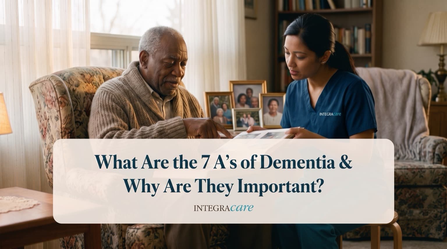 A caregiver looks through a photo album with a senior man beside framed family photographs