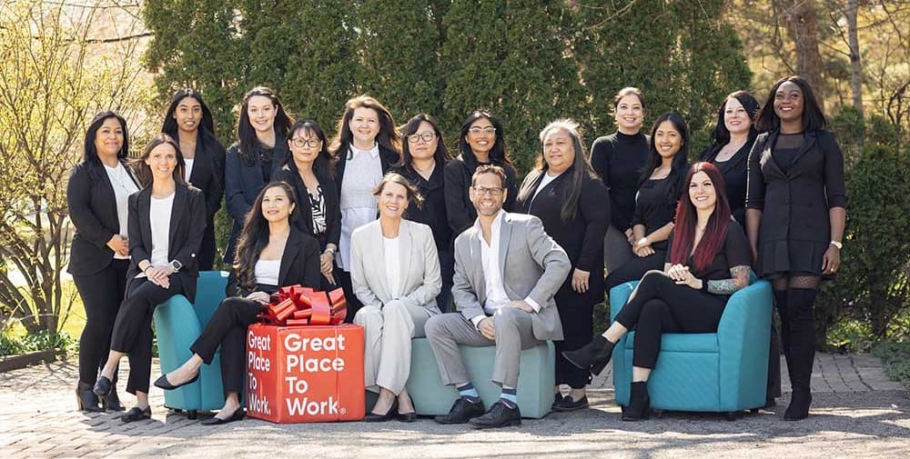 The Integracare team together outdoors with their Great Place to Work award