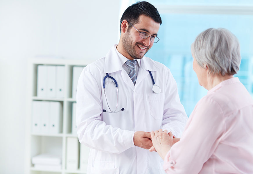 Picture of doctor holding hands of senior