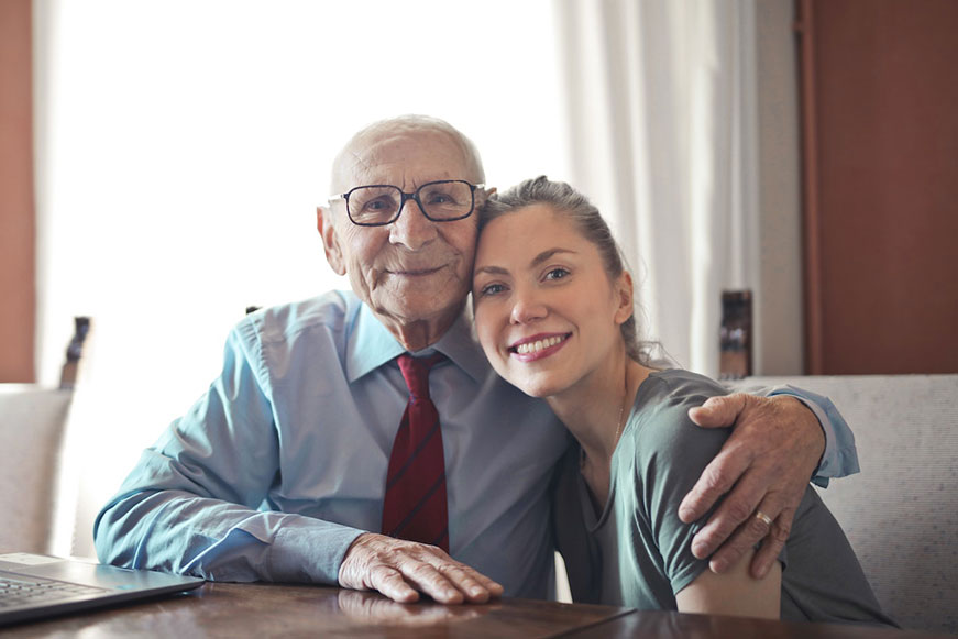 Image of senior with arm around support worker