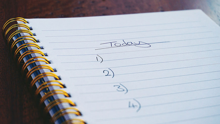 A close-up of a ring bound, lined notepad. It says ‘Today’ on the notepad with one to four written below.