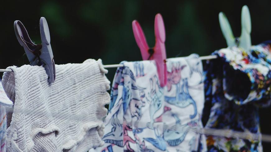 White and blue floral clothing hanging outside to dry