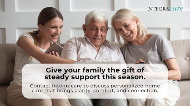Two women sitting with their elderly father and smiling, illustrating Integracare’s personalized home care and holiday family support services.