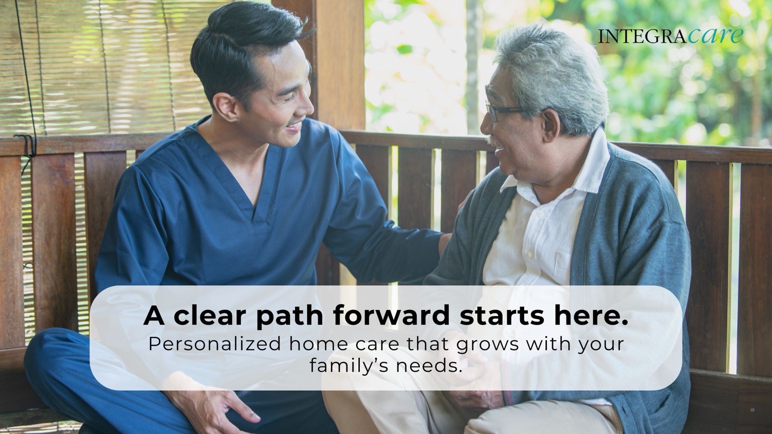 A caregiver sitting with an older man on a porch, providing compassionate, personalized home care support for aging parents.