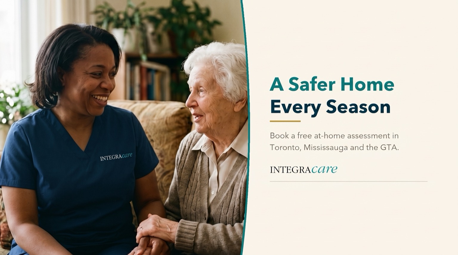 Caregiver in navy scrubs sharing a laugh with a senior woman on a couch in her living room